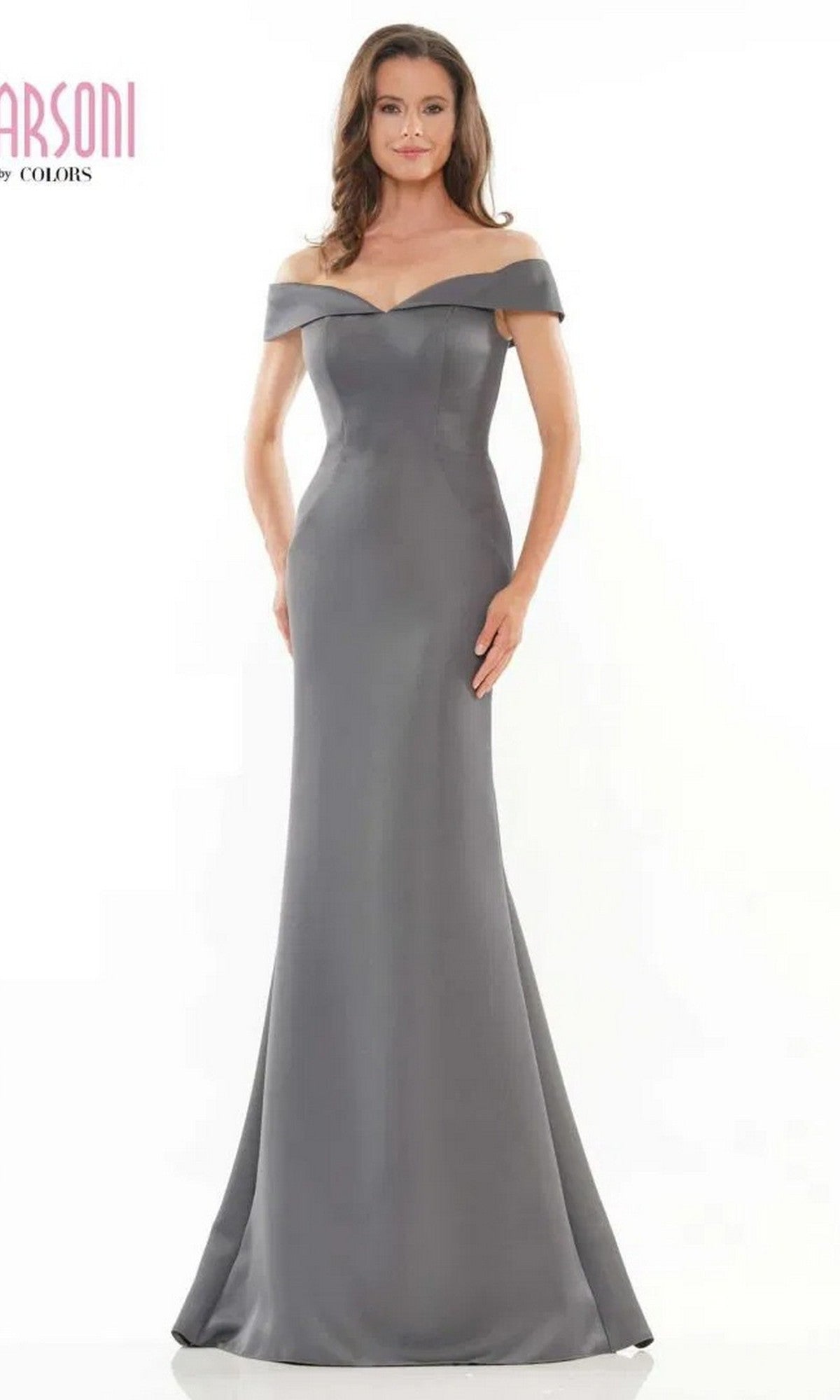 A woman models the Marsoni MV1153 long formal dress in charcoal, featuring a fitted off-the-shoulder design, against a plain white background.